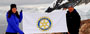 Woman & man holding Rotary flag in the Antarctic